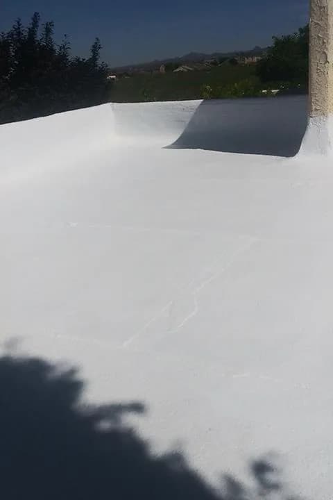 White roof coating carried up the inside face of a parapet wall
