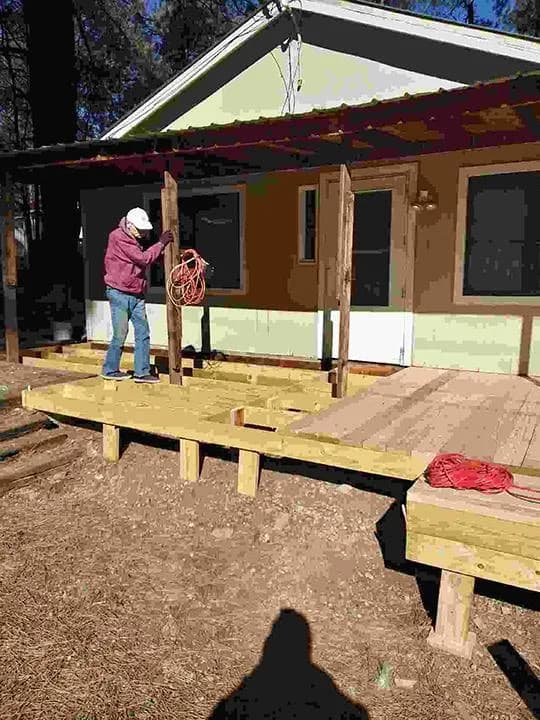 New timber porch deck being framed along the front of a house